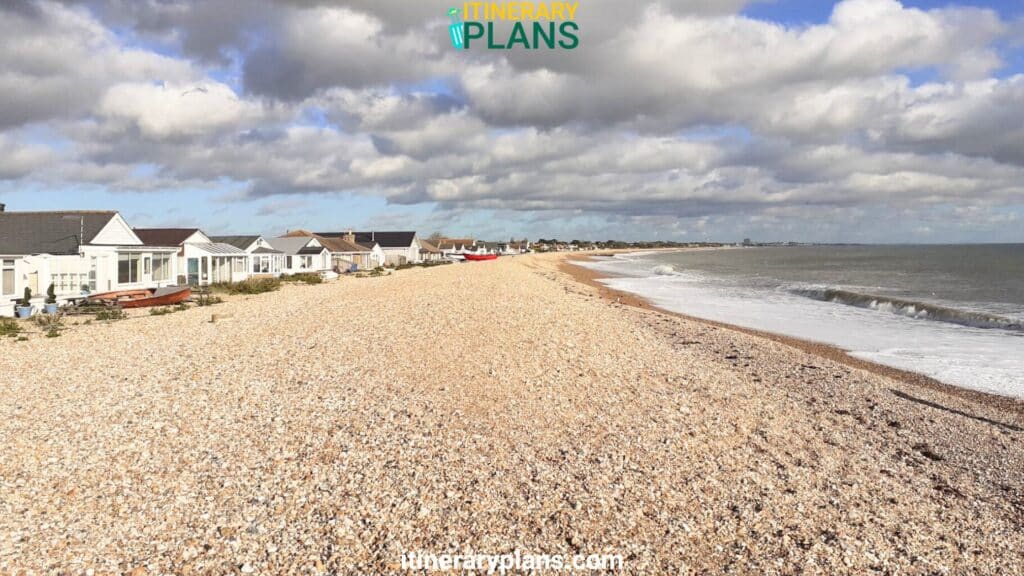 Pagham Beach brown rock near house with cloudy sky