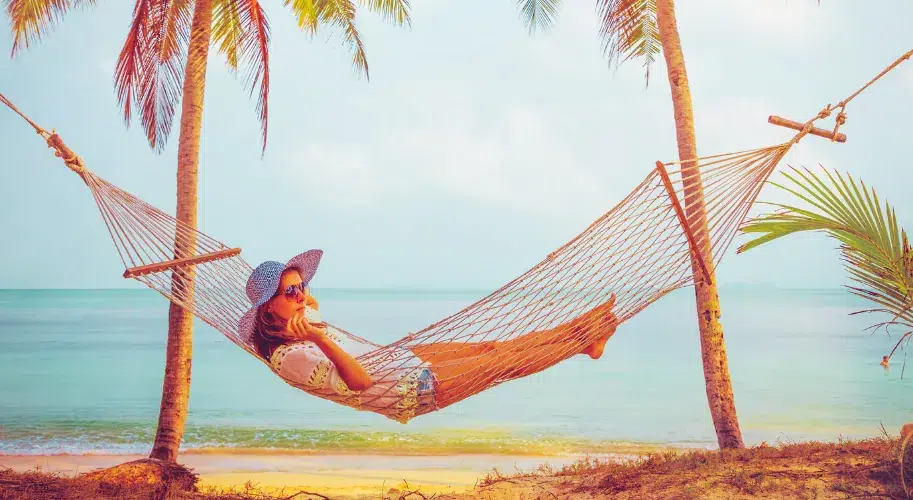 Tourist relaxing on hammock at Marari Beach Kerala