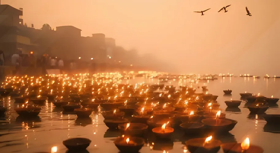 Thousands of diyas floating on the Ganga River during Diwali in Varanasi.