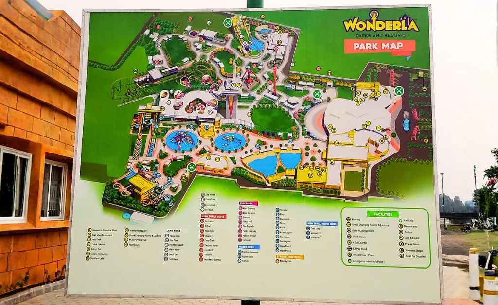 Large outdoor park map of Wonderla, showing various attractions, water rides, and facilities, surrounded by lush greenery. Bright and colorful design, with a legend at the bottom outlining rides and amenities. Logo at the top right.